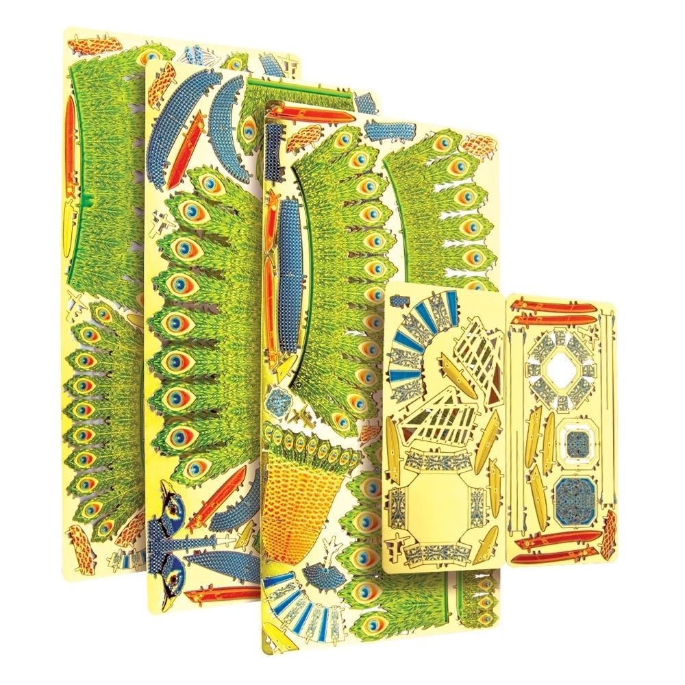 Set of decorative metal cutouts with peacock designs on a white background
