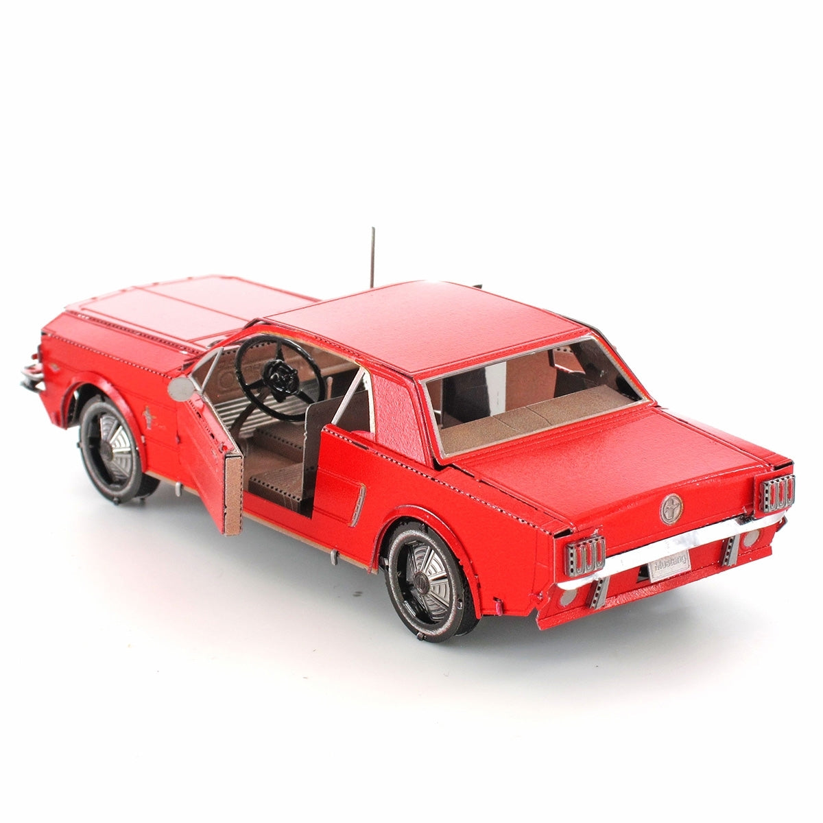 Red metal model of a 1965 Ford Mustang car on a white background