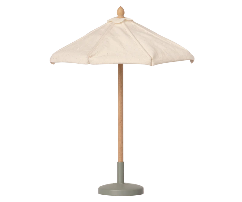 A small Maileg Sunshade, Miniature with a cream fabric canopy, a natural wood pole, and a muted sage green base, shown against a plain white background.