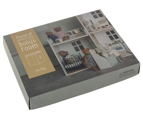 A boxed Maileg House of miniature - Bonus room set photographed on a plain white background. The package shows a printed room scene with teddy bears and furniture, plus a tan label reading 'House of miniatures Bonus Room' and the brand 'Maileg'.