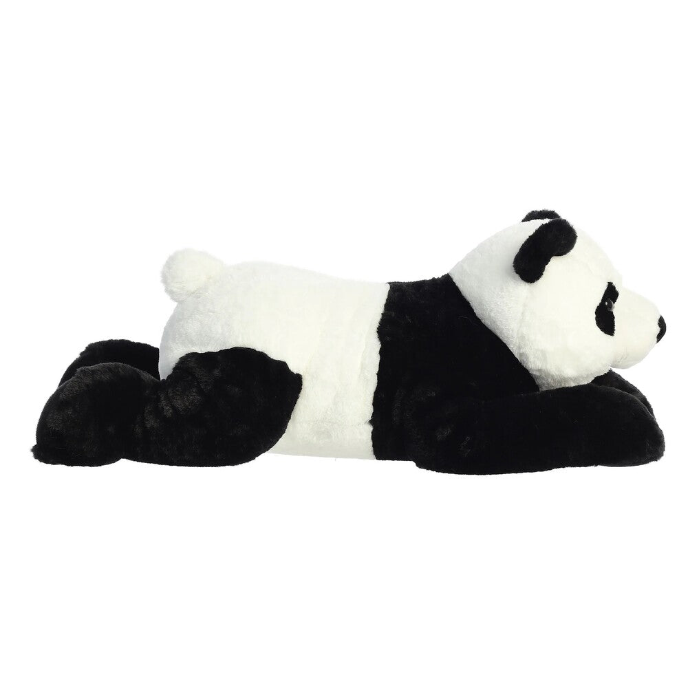 Plush panda toy lying down on a white background