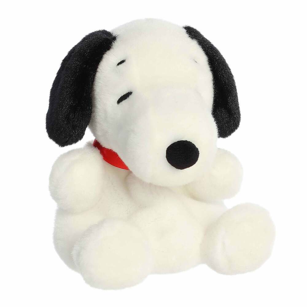 Plush toy of a black and white dog with a red collar on a white background