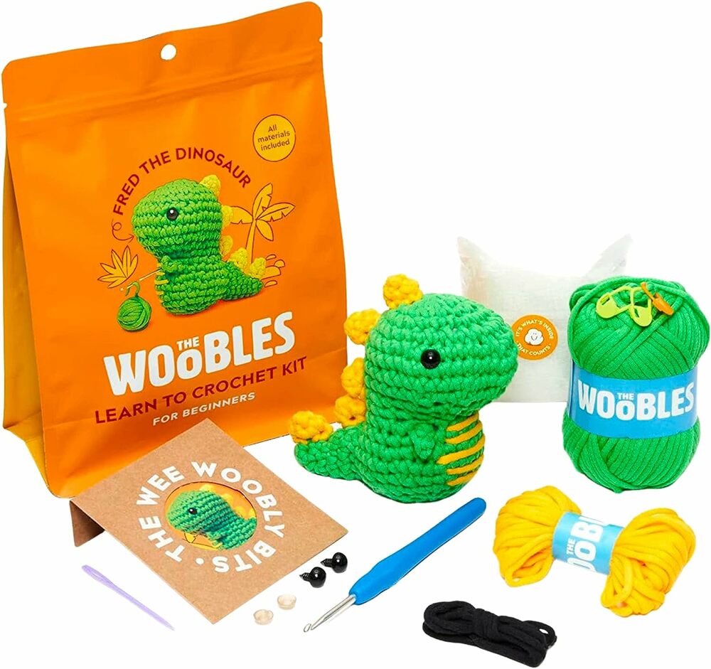 Dinosaur Fred Beginner Crochet Kit with green dinosaur toy, yarn, and tools on a white background