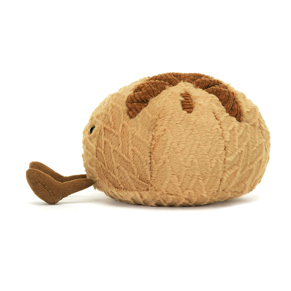 Plush toy shaped like a round sourdough loaf with embroidered crust details and a small brown tail, representing the Amuseables Sourdough soft toy.
