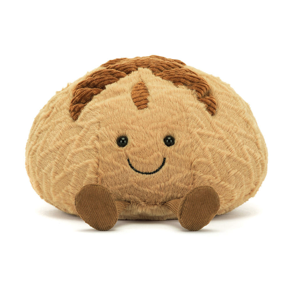 Soft plush toy resembling a smiling sourdough loaf with textured brown details and small round eyes, called Amuseables Sourdough.