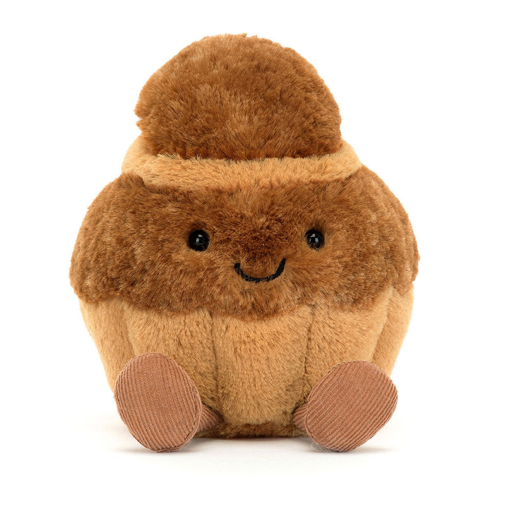 Soft brown plush toy shaped like a smiling brioche bun with small corduroy feet, called Amuseables Brigitte Brioche, perfect as a cuddly kid's gift.