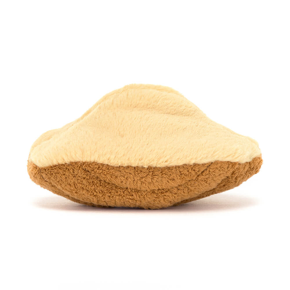 Soft plush toy shaped like a golden-brown Madeleine cookie, featuring two-tone beige and brown fabric, designed as Amuseables Margaux Madeleine.