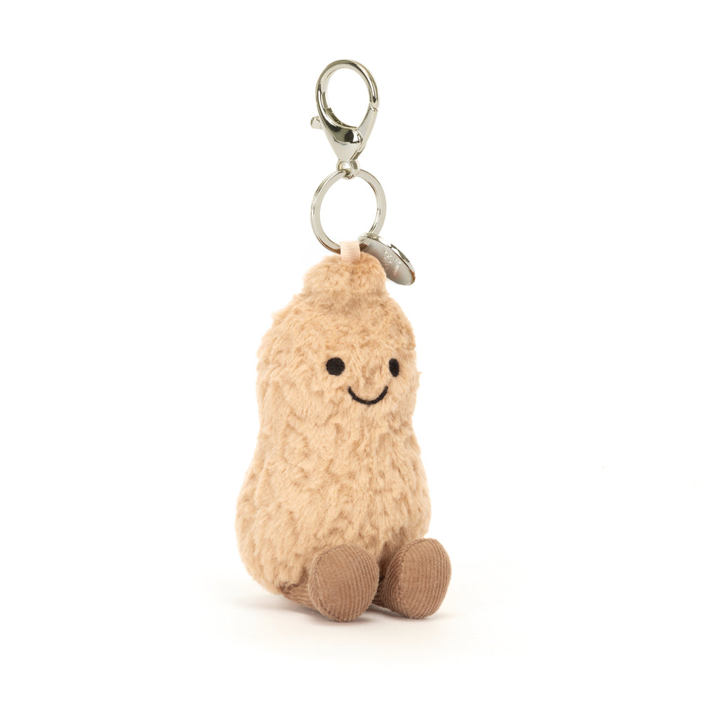 Soft plush Peanut Bag Charm with a smiling face and small seated legs, attached to a silver clasp keychain for easy bag or backpack decoration.
