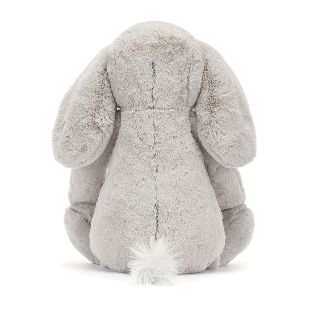 Back view of a soft, plush gray stuffed animal with long ears and a tufted tail, representing the Bashful Luxe Elephant Thuddeus Huge plush toy.