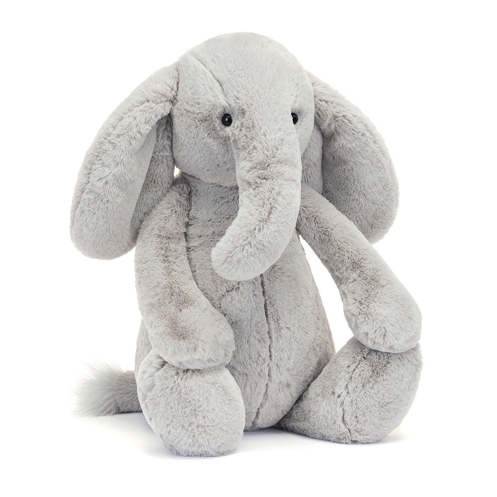 Soft and cuddly gray plush elephant with large floppy ears and a gentle expression, perfect for toddlers and children, named Bashful Luxe Elephant Thuddeus.