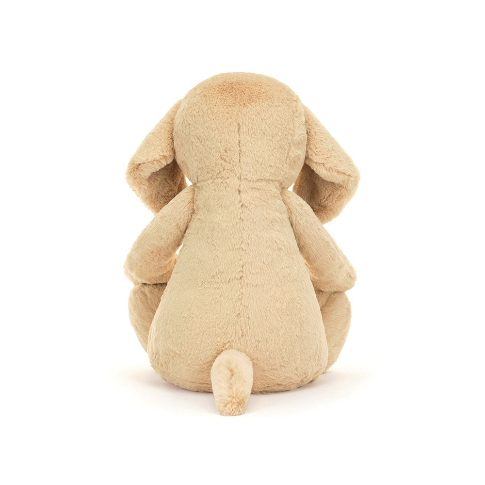 Soft beige plush puppy stuffed animal sitting with back facing forward, showcasing floppy ears and small tail, named Bashful Luxe Puppy Orlando Huge.