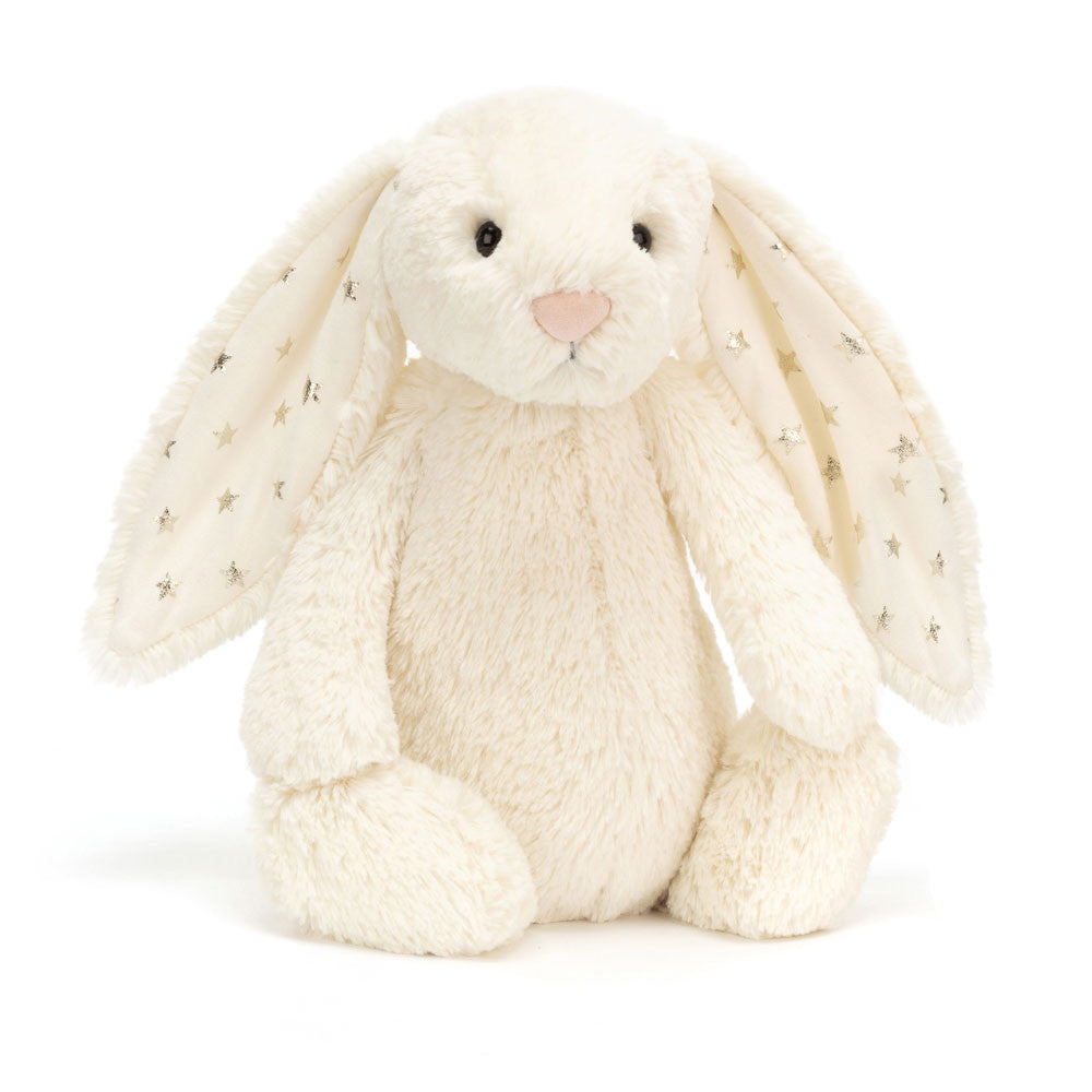 Bashful Twinkle Bunny is a soft cream-colored plush rabbit with long ears lined with fabric featuring silver star patterns, perfect as a cuddly toddler toy or gift.
