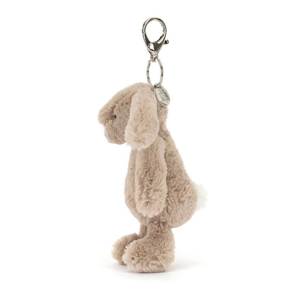 Soft plush beige bunny with floppy ears and a metal clasp for attaching to bags or keys, featuring the Bashful Beige Bunny Bag Charm.