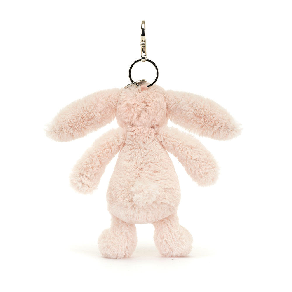 Bashful Blush Bunny Bag Charm featuring a soft, blush pink plush bunny with long ears, a round tail, and a metal clip for attaching to bags or keys.