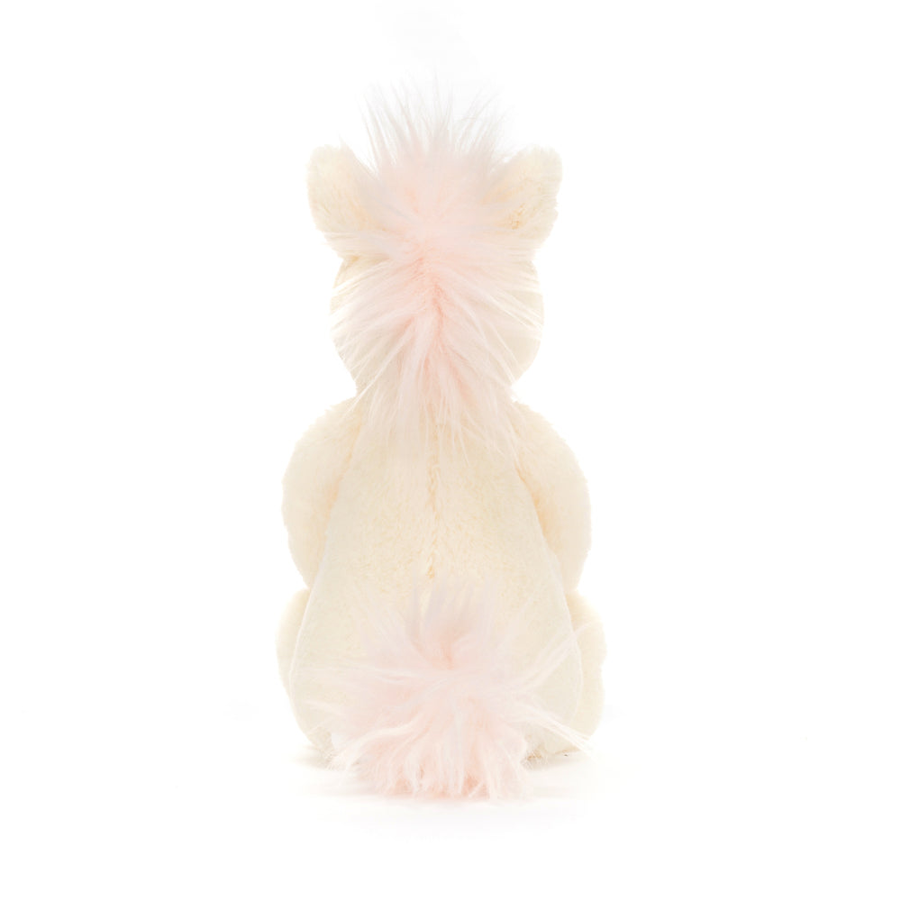 Plush Bashful Unicorn Small toy seen from the back, featuring soft cream-colored fur and light pink fluffy mane and tail, perfect as a toddler toy or stuffed animal.