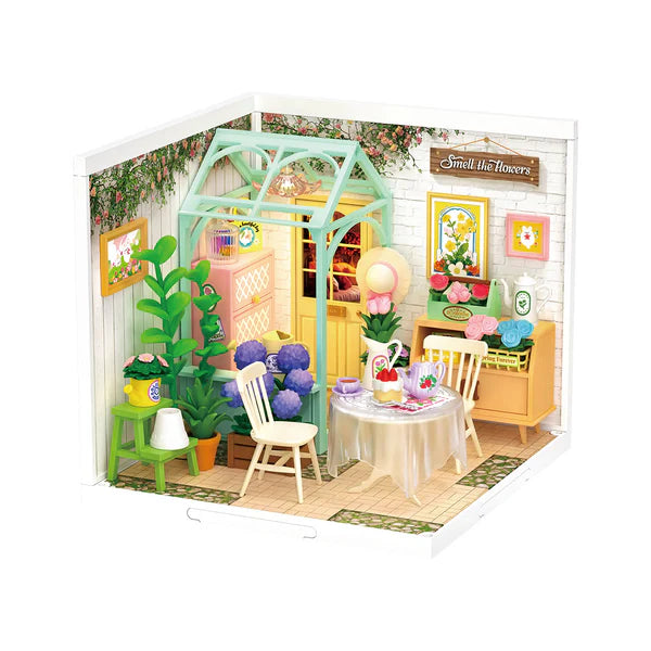 Blooming Tea Garden DIY Miniature House with floral decorations and furniture on a white background