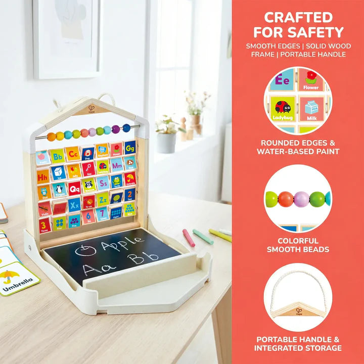 Children's educational Alphabet Learning Pack with colorful letters and numbers on a wooden stand, placed on a table.
