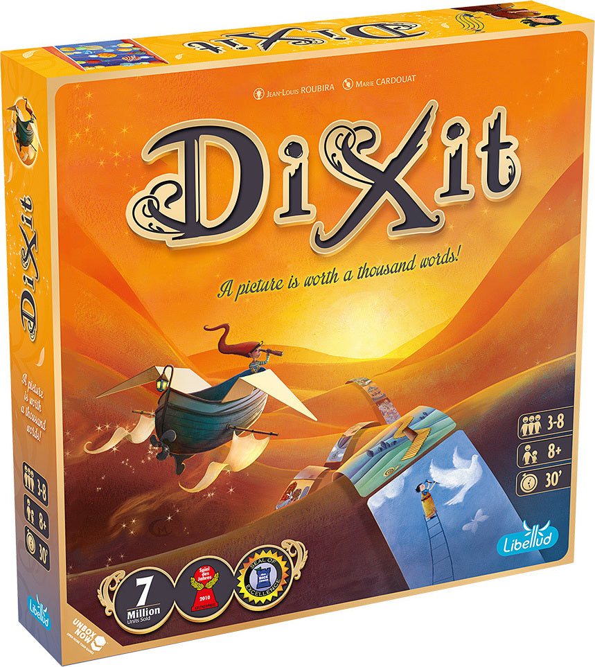 Board game box for Dixit with desert scene and text 'A picture is worth a thousand words!'