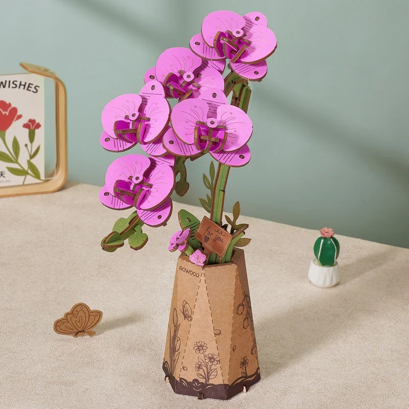 Purple Moth Orchid DIY Wooden Flower with pink flowers on a beige surface.