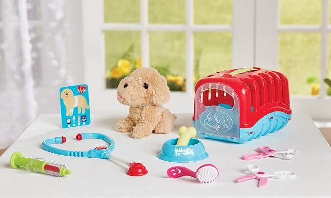 Children's toy Groom 'n Care Pet Carrier with a red pet carrier, plush dog, and various toys on a white surface.