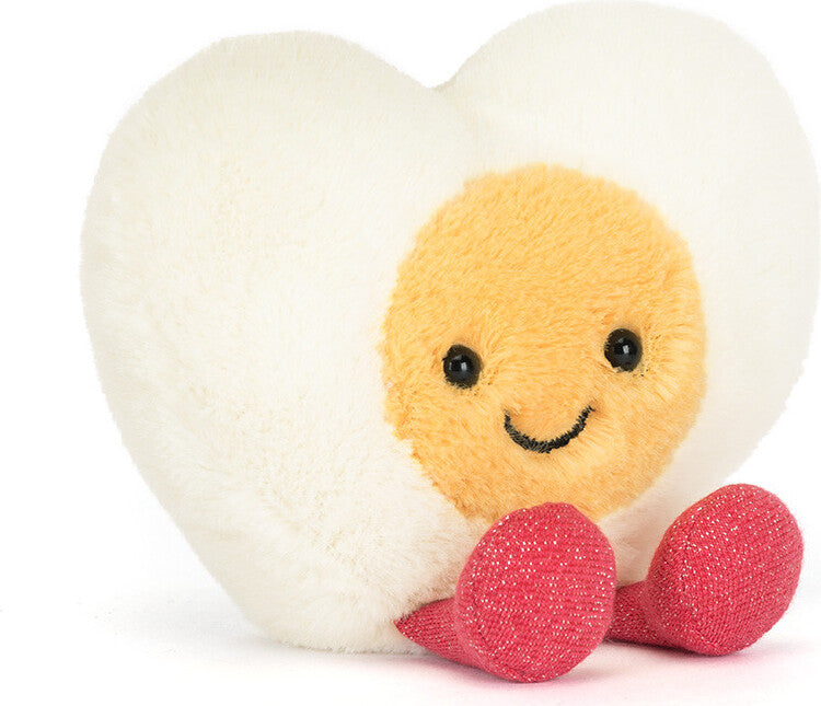 Soft plush Amuseables Heart Boiled Egg toy with a smiling face and red fabric feet, designed as a cute and friendly stuffed animal for children.