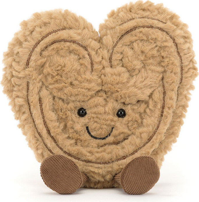 Amuseables Philippe Palmier is a soft, plush toy shaped like a smiling palmier pastry with textured fur and small round feet, perfect for children’s imaginative play.