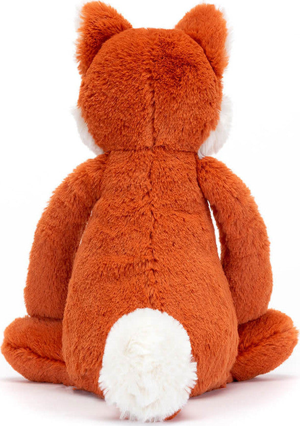 Back view of Bashful Fox Cub Medium plush toy showing soft orange fur, fluffy white tail, and seated posture, perfect as a cuddly stuffed animal for children.