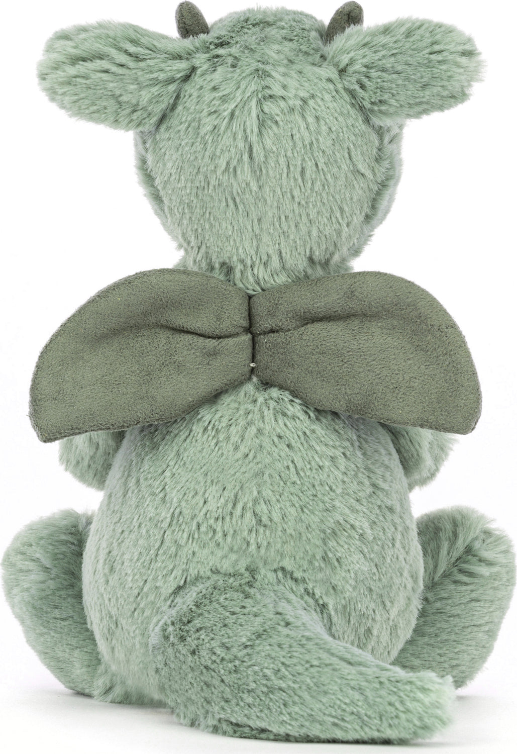 Soft green plush Bashful Dragon Small toy shown from the back, featuring fuzzy fabric, small wings, horns, and a curled tail, perfect as a cuddly stuffed animal for kids.