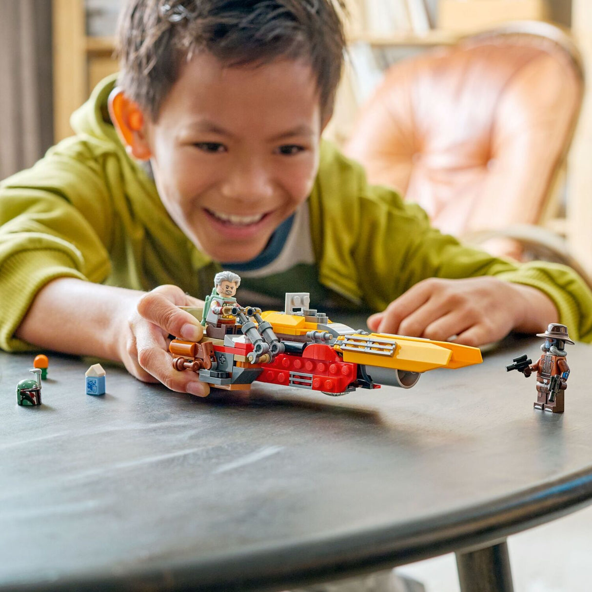 Child playing with a LEGO Star Wars: Cobb Vanth's Speeder