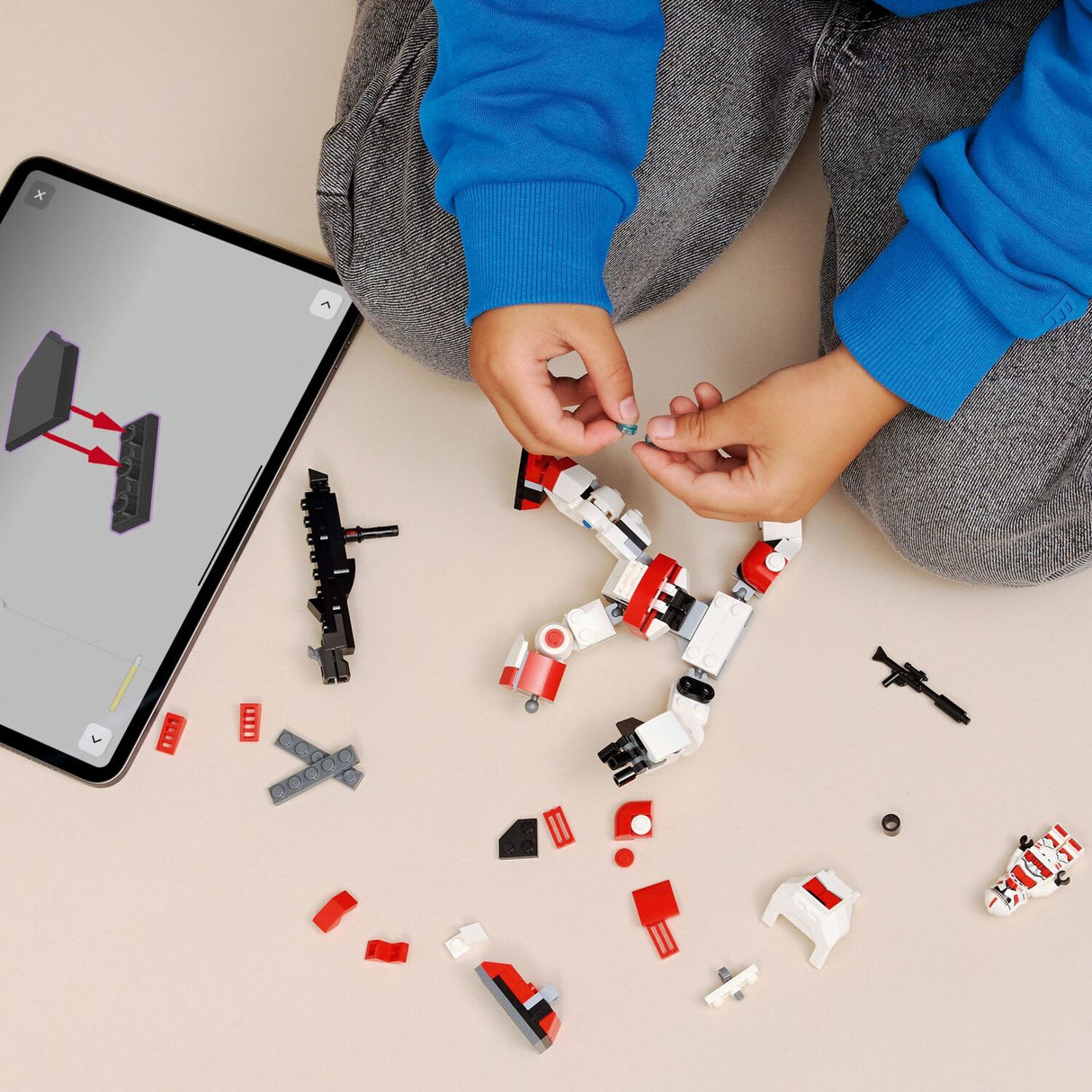 Child building a LEGO Star Wars: Clone Shock Trooper™ Mech