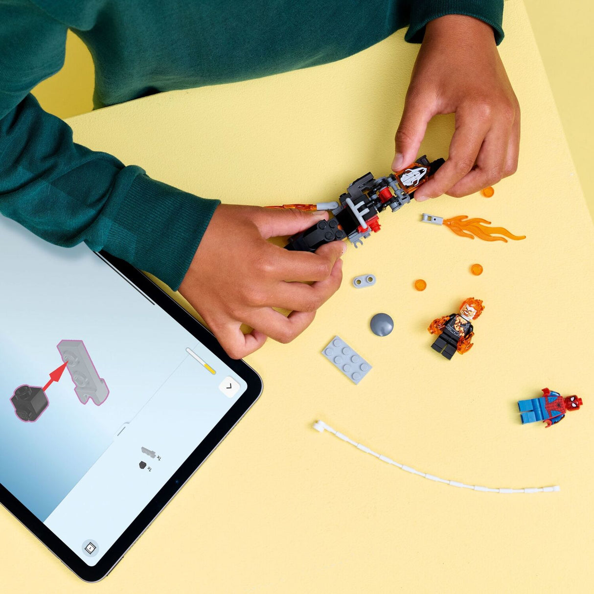 Child building LEGO Super Heroes Marvel: Spider-Man vs. Ghost Rider Motorcycle