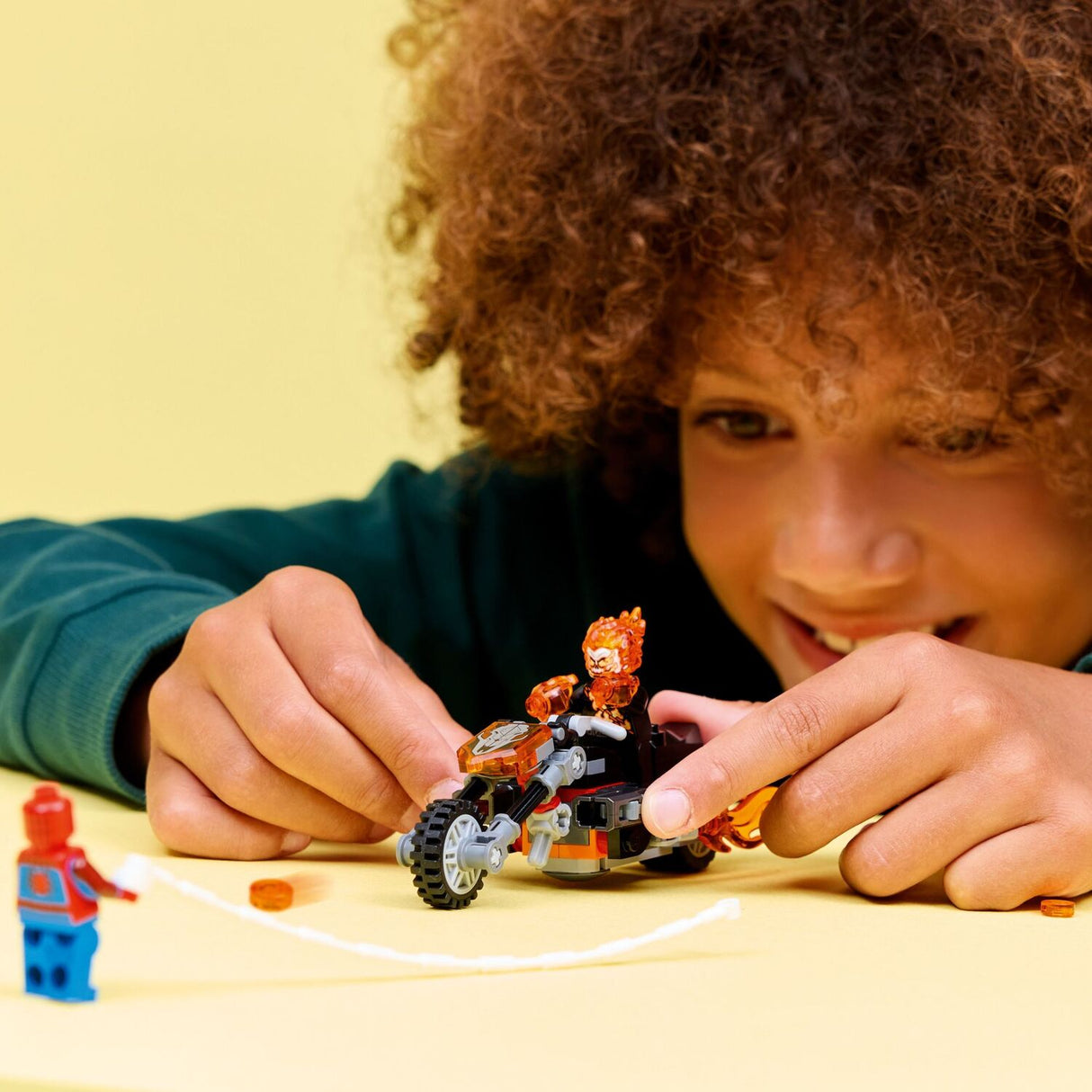 Child playing with LEGO Super Heroes Marvel: Spider-Man vs. Ghost Rider Motorcycle