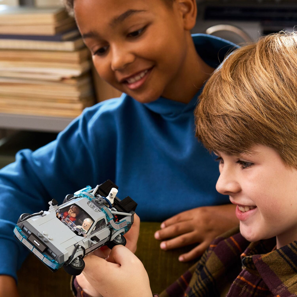 Child holding a LEGO Speed Champions: Time Machine from Back to the Future