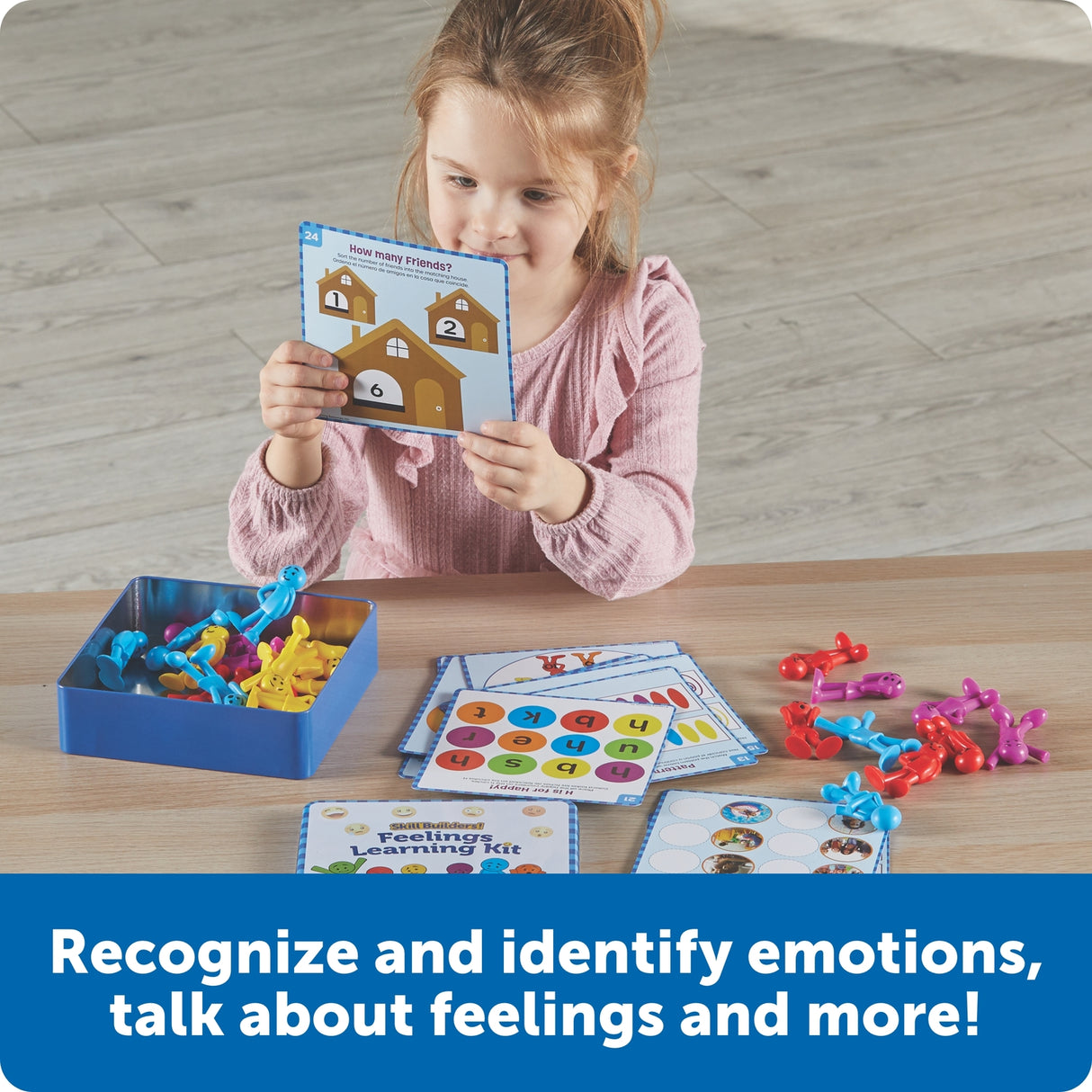 Child playing with educational toys and cards on a wooden table