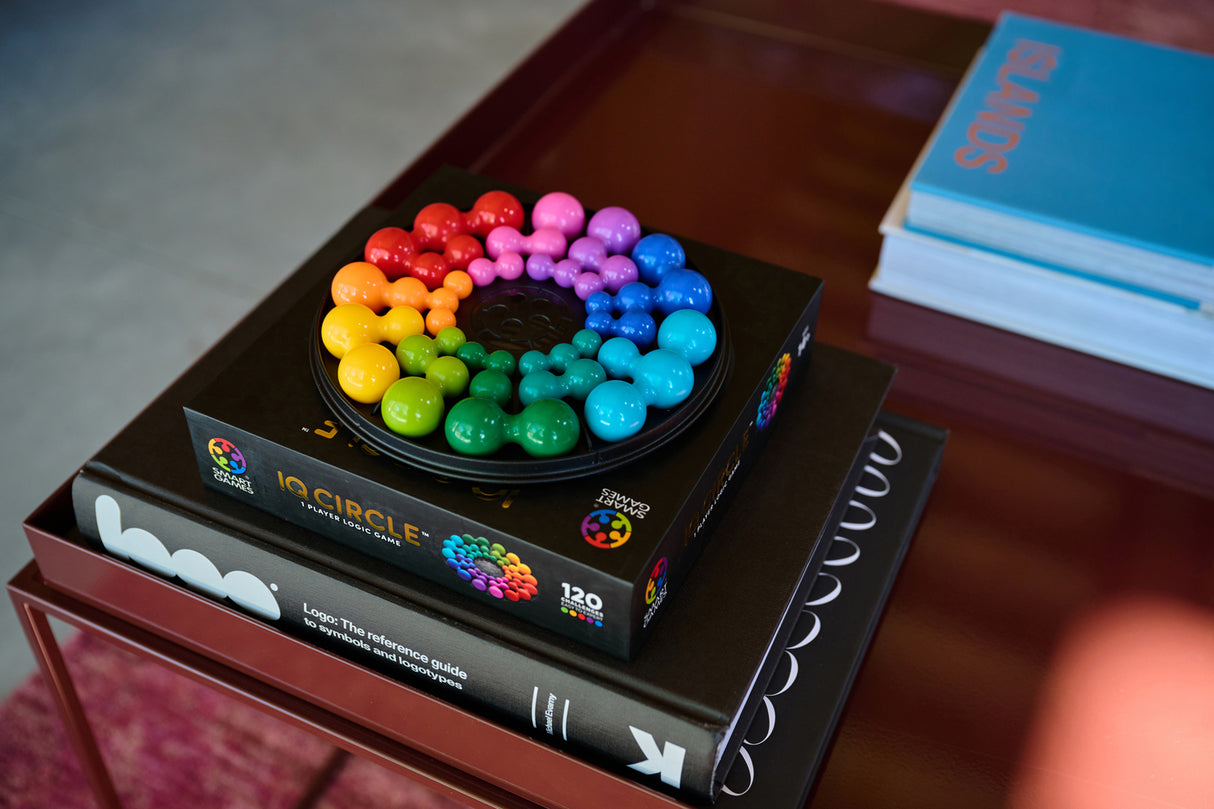 Colorful IQ Deluxe - Circle puzzle on a book with a blurred background