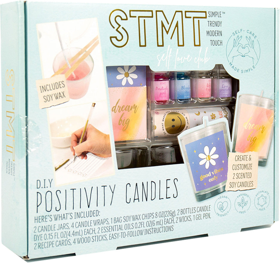 STMT DIY Positivity Candles kit packaging with candles and supplies on a light blue background
