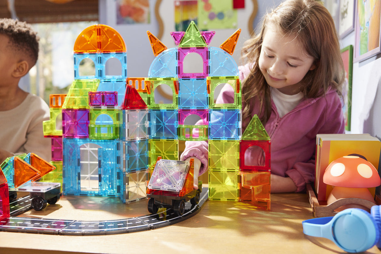 Children playing with Magna-Tiles City Center 110 Piece Set on a table.