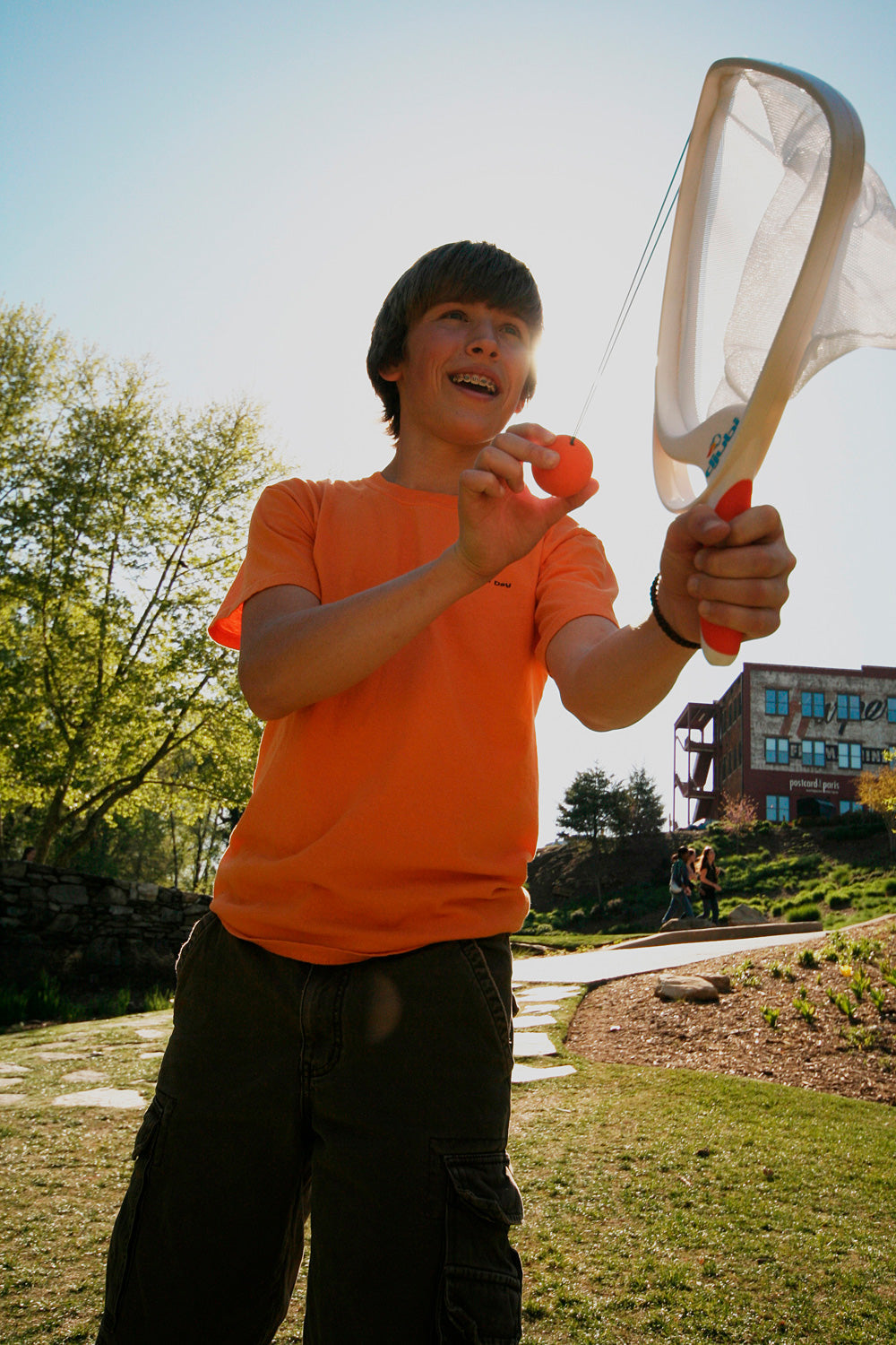 Person holding a Djubi SlingBall Classic outdoors