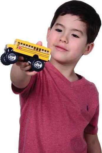 Child holding a toy Monster School Bus against a white background