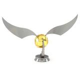 Metal model of a Golden Snitch with wings on a white background
