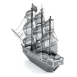 Metal model  of the Black Pearl ship of a three-masted sailing ship on a white background