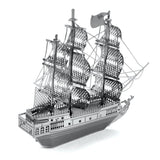 Metal model  of the Black Pearl ship  with multiple masts on a white background