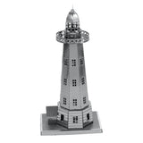 Metal model of a lighthouse on a white background