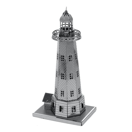 Metal model of a lighthouse on a white background