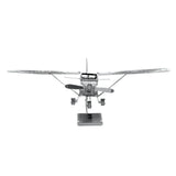 Metal model of a Cessna 172 airplane with wings on a white background