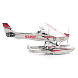 Metal model of a Cessna 182 Floatplane  with a white body, red accents, and visible registration number N346QY on a white background.