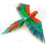 Colorful metal parrot model with red, green, and blue feathers on a white background