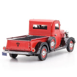 Metal model of a 1937 Ford Pickup  red truck with black accents on a white background