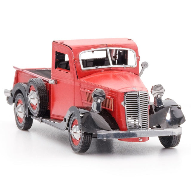 Metal model of a 1937 Ford Pickup red truck on a white background