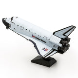 Metal model of Space Shuttle Discovery on a white background